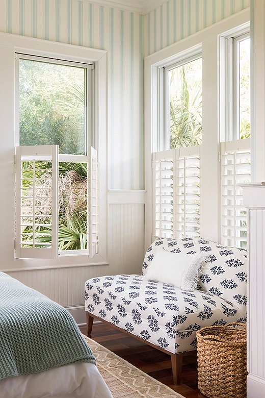 The settee transforms a corner of the guest bedroom into a sitting area—ideal for taking advantage of the breezes wafting through the shutters. Find the rug here and the pillow here. 
